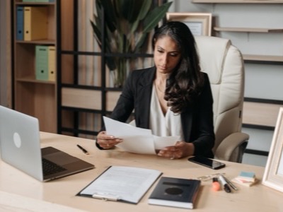 Woman reviewing documents at an office desk